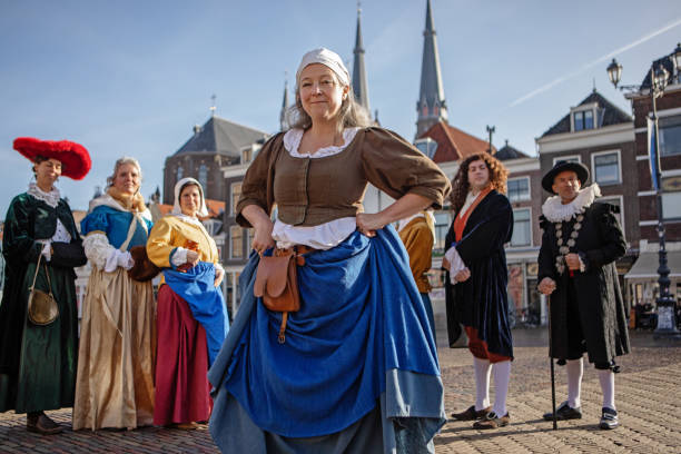 A group of seven traditionally dressed male and female tourist guides in Delft on a spring day