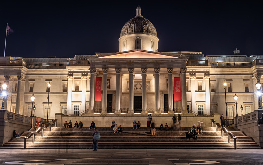 London. UK- 02.04.2024. A full frontal exterior view of the National Gallery at night time.