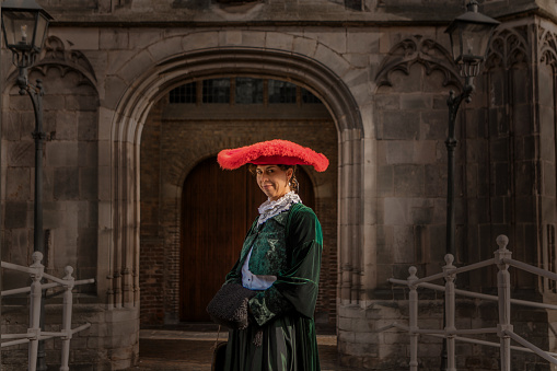 Portrait of a tour guide girl with a red hat in Delft