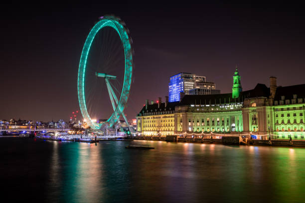 London SE1, United Kingdom. 08/16/2024 - Jubilee Gardens & The London Eye, Southbank Centre, Royal Festival Hall -Event venue, Millennium Wheel, Waterloo Bridge - a significant road and foot traffic bridge crossing the River Thames in London. London SE1, United Kingdom.\n\nFrom Waterloo Bridge, Buildings, Architecture. night-time city scene; panoramic views of landmarks.