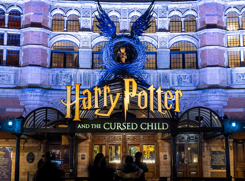 London. UK- 02.04.2024. A night time view of the main display on the facade of the Palace Theatre for the show Harry Potter and the Curse Child.