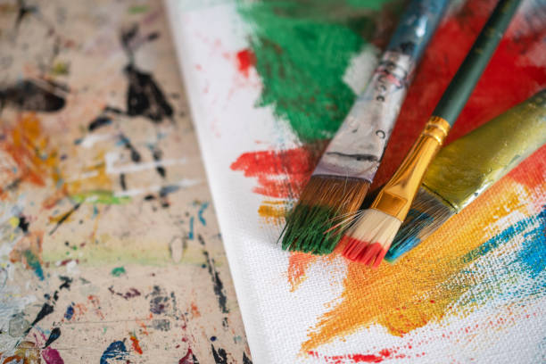 istock painting lessons, canvas with paints, brushes and other elements for painting 1992341983