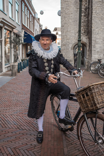 Portrait of a tour guide Mayor Hoogenhouck in Delft on a bike
