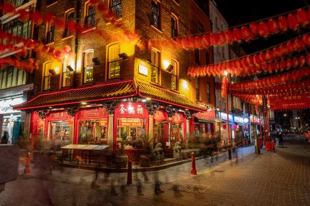 London. UK- 02.04.2024. A long exposure night time view of China Town showing one of its many restaurants and decorated with colourful lanterns for the coming Chinese New Year celebration.