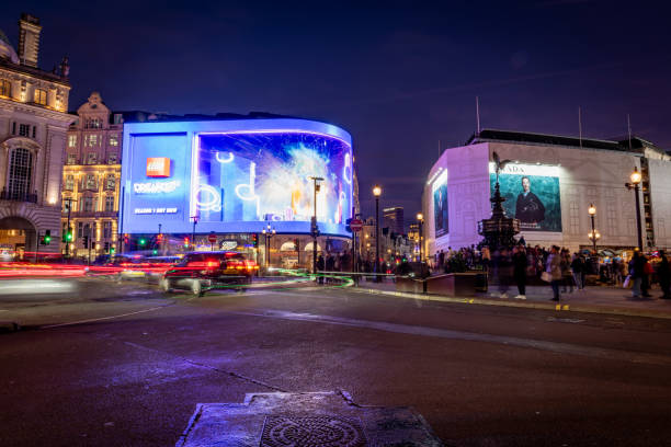Leicester Square in Central London, England, United Kingdom, GB. 19th December 2024. A street view captured in the evening during the Christmas holiday season in central London, UK. Pedestrians walk on the street.