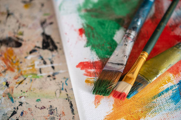 istock painting lessons, canvas with paints, brushes and other elements for painting 1992345772