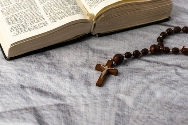 istock Holy bible and rosary on a table 1992346884