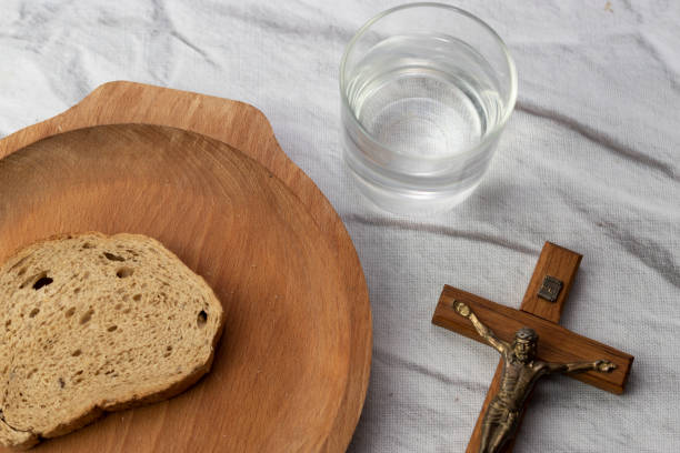 istock Lent - bread, water and crucifix 1992351181