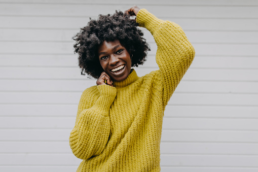 Young black fashionable female student looking at camera and smiling