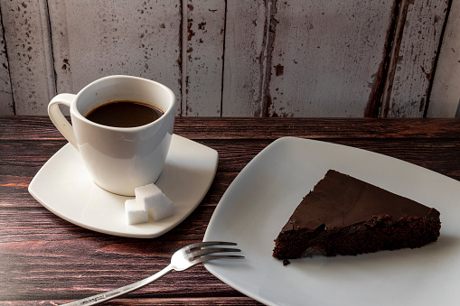 Chocolate cake on a plate and coffee