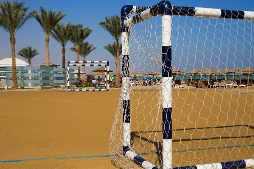 Beach soccer field. Gates with mesh for active sports on holiday by the sea with a sandy beach