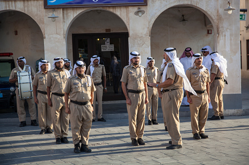 Doha, Qatar-December 16,2023 : Police in traditional dress on front of the police station in the market called \