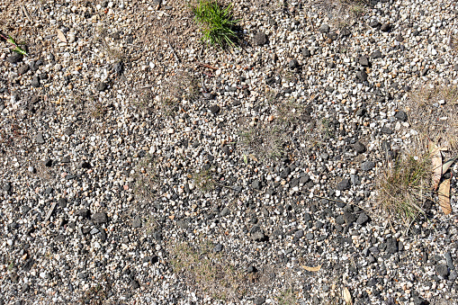 dry australian ground with gravel and light vegetation