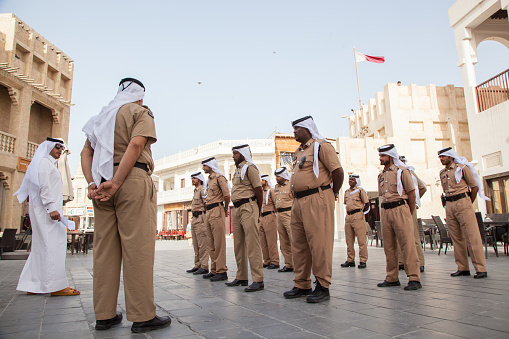 Doha, Qatar-December 16,2023 : Police in traditional dress on front of the police station in the market called \