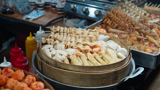 dim sum with several variants of warm cakes on a large steamer made of bamboo