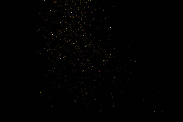 istock group of small golden flakes are scattered on the black surface 1992386764