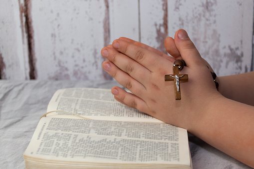 Praying kid with holy bible