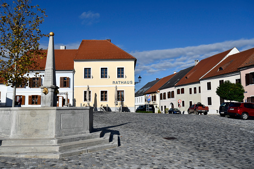 Stadtschlaining, Austria - November 07, 2023: The town's cobbled main square with town hall and fountain