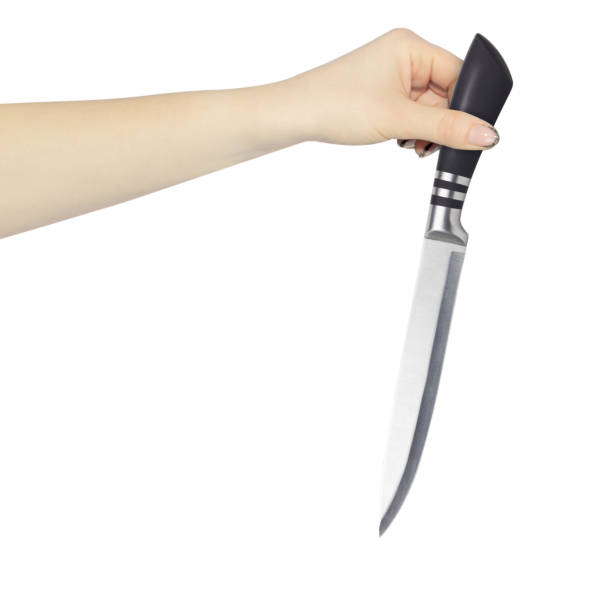 istock kitchen knife in hand, outstretched hand with kitchen knife isolated from background 1992416919