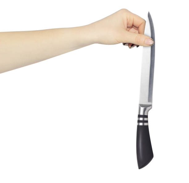 istock kitchen knife in hand, outstretched hand with kitchen knife isolated from background 1992416925