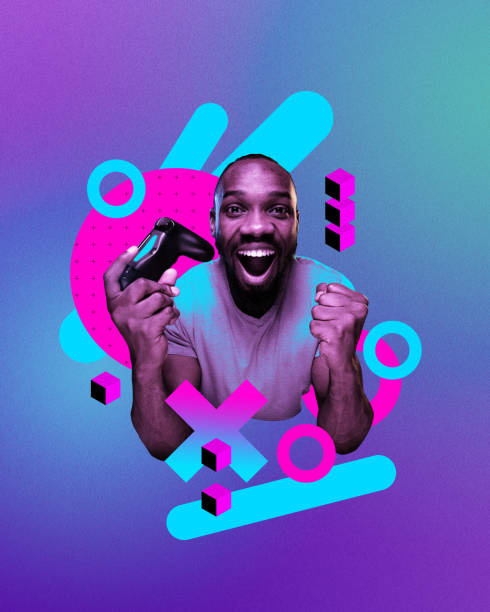 istock Happy smiling African man with game controller showing winning emotions, playing online video games against gradient neon background. Streaming. Online gaming culture 1992436834