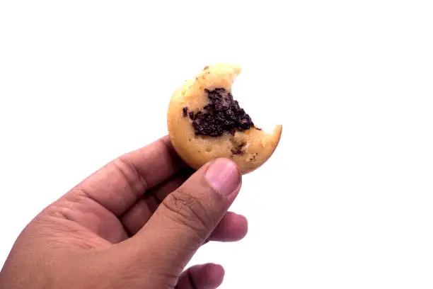 Photo of Kue Cubit is a popular snack in Jakarta, Indonesian version of Dutch poffertjes. Topped with chocolate sprinkles, served on a white plate and isolated on a white background.
