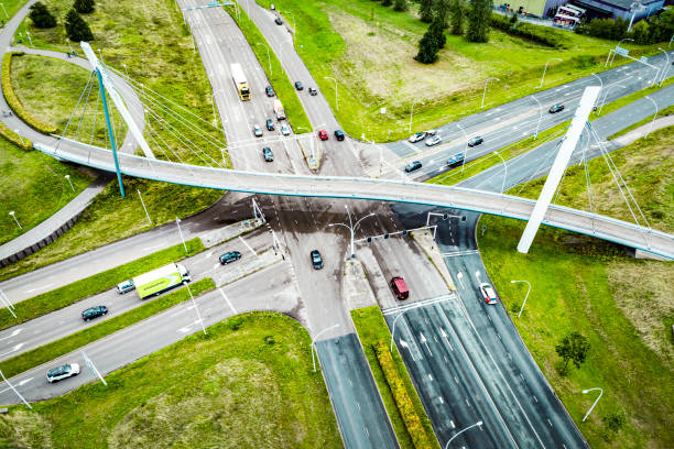 traffic at a junction with a winding bicycle path bridge seen from above - traffic sea passage overpass car ストックフォトと画像