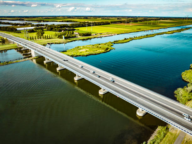 Traffic driving over a bridge over a lake in a nature reserve