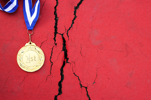 Top view image of medal on asphalt floor