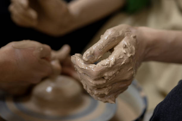 istock A woman's hand in clay after starting work on a potter's wheel. Close-up 1992458929