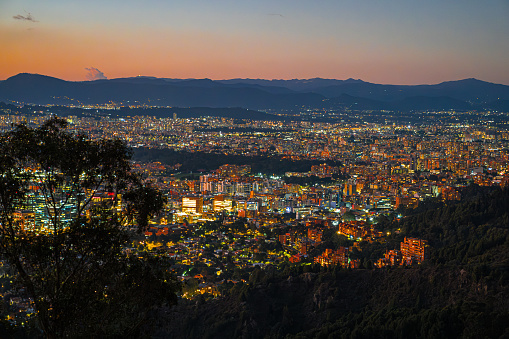 As dusk descends upon Bogotá, Colombia's mountain-framed capital, the sky above unveils a magnificent spectrum of colors, mirroring the city's own vibrant diversity. In these three images, the sprawling urban landscape of Bogotá comes to life under the transitioning twilight. From the first image, where the sunset casts a golden hue over the city, creating silhouettes of clouds that herald the night, to the second, where the sky erupts in a fiery orange, offset by the cool blue of the emerging stars, each moment reflects the city's dynamic heartbeat. The third captures the final act, where the night curtain has been fully drawn, and the city lights twinkle like a terrestrial constellation. This sequence captures not only the contrasting beauty of day turning into night but also the energy and spirit of one of South America's most populous cities, nestled in the Andean highlands.
