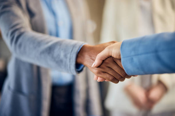 istock Close-up of two female clients shaking hands. 1992470816