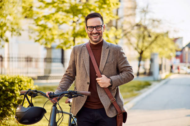 istock Portrait of a businessman pushing a bicycle, and going home from work. 1992472367
