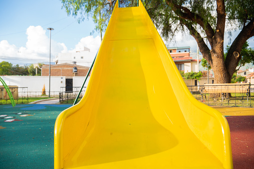 yellow slide in an urban playground