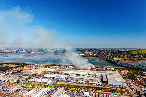 Fire sets out at a waste facility sending smoke in Onehunga, Auckland which many fire fighting vehicles attend