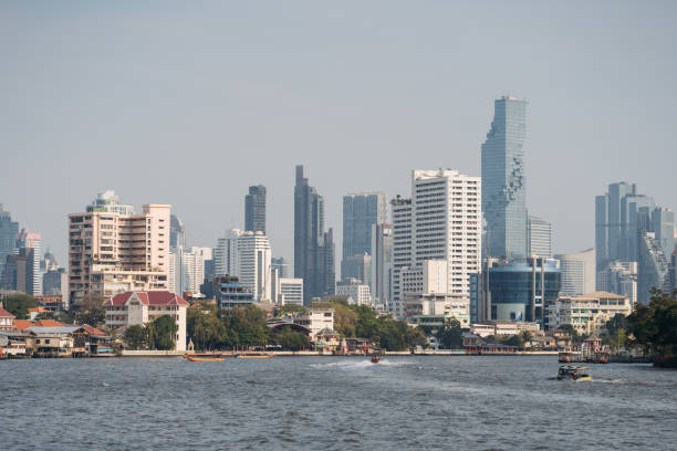 istock Bangkok Riverside with Boats and Skyline. 1992516940
