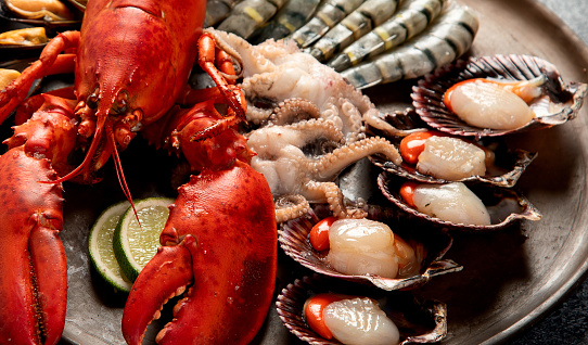 boiled crayfish with dill on wooden table