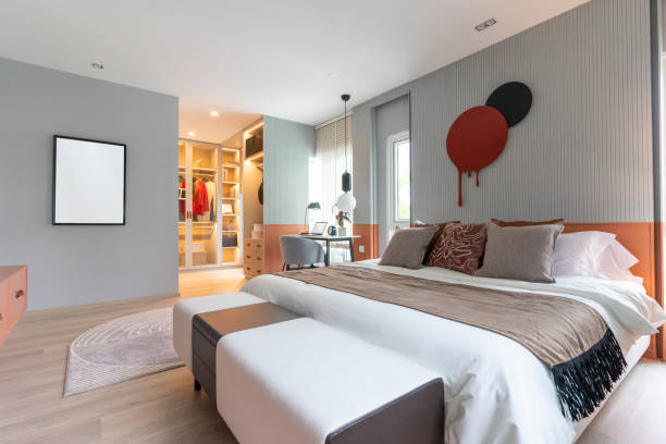istock Modern bedroom interior with black and red wall art hanging. 1992553485
