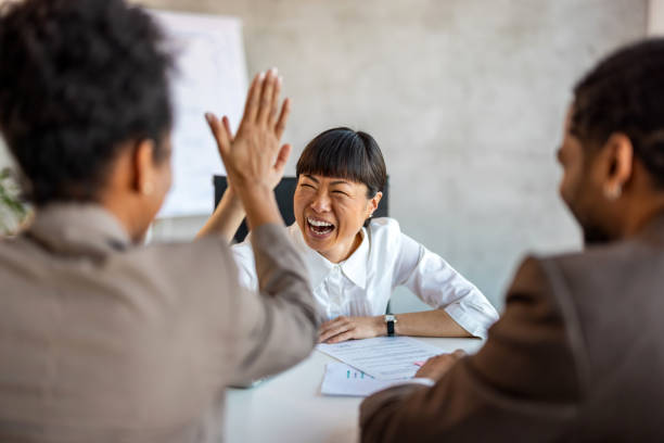istock Business people celebrating success in an office 1992569616