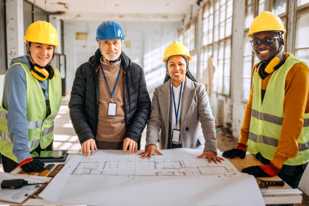 istock Architects looking at the architectural project and explaining to construction worker what to do 1992586898