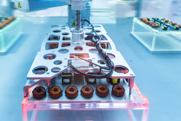 istock artificial intelligence machine at industrial manufacture factory for toroidal coils with magnetic ferrite core wrapped in copper wire on electronic components pile 1992588999