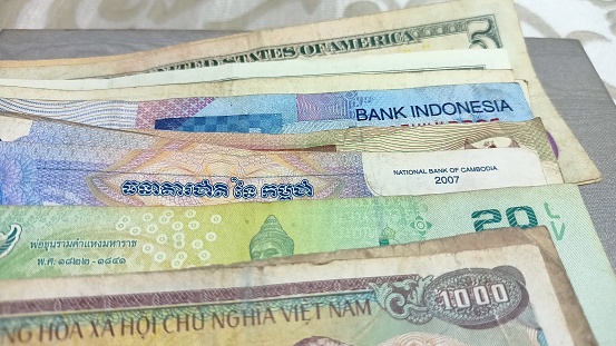 A mix of different Bank notes currency from America dollar, Vietnam Dong, Indonesia Rupiah, Thailand Baht etc