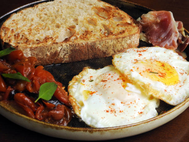 istock Delectable brunch featuring artisanal bread, fried eggs with a hint of sweet paprika. 1992616165