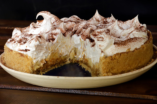A closeup of Banoffee Cake on a wooden background.