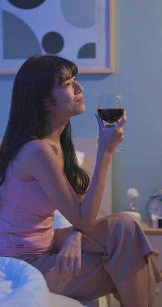 istock asian woman red wine bedtime 1992620699