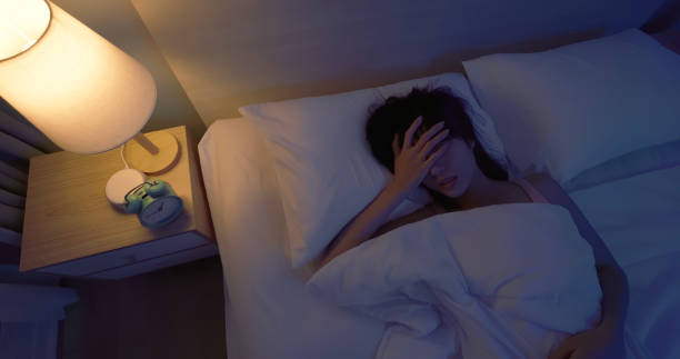 asian woman sleepless at night Top view asian woman laying on bed sleepless at night woman sleeping in bed at night stock pictures, royalty-free photos & images
