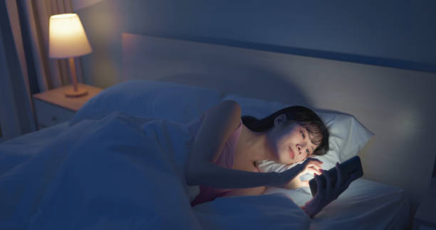 istock woman scroll smartphone dark room 1992624586
