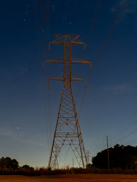 Electricity pylon/ Transmission tower against a starry night sky.