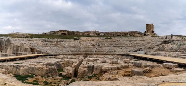 Syracuse, Italy - 28 December, 2023: panorama view of the Greek Theater in the Neapolis Archaeological Park in downtwon Syracuse