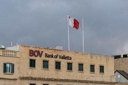 Valletta, Malta - 23 December, 2023: view of the Bank of Valletta headquarters building in Valletta with the Maltese flag on the roof